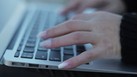 Close-up-shot-of-female-hands-typing-on-keyboard-of-laptop
